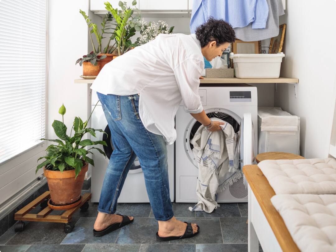 A woman loading the washing machine