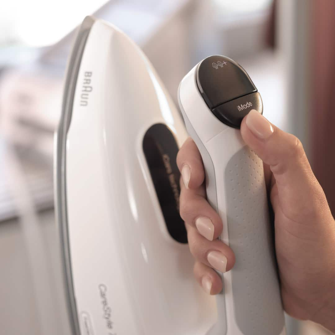 A person holding an iron in their hand