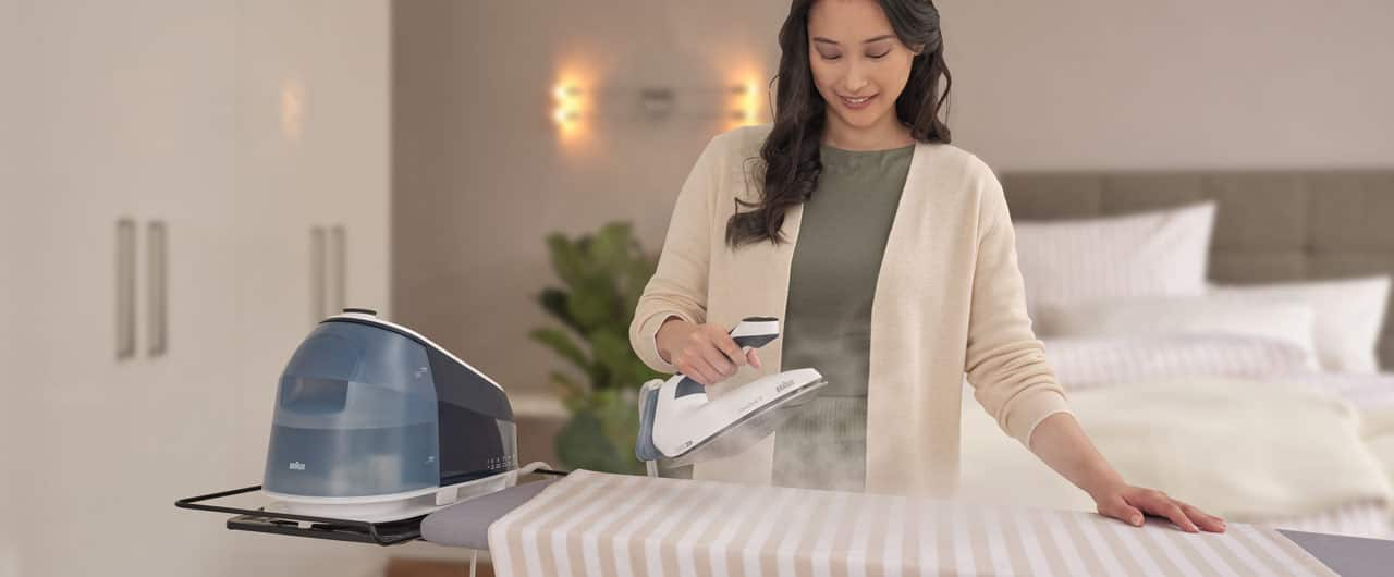 Woman ironing with a Braun CareStyle 5 steam generator iron