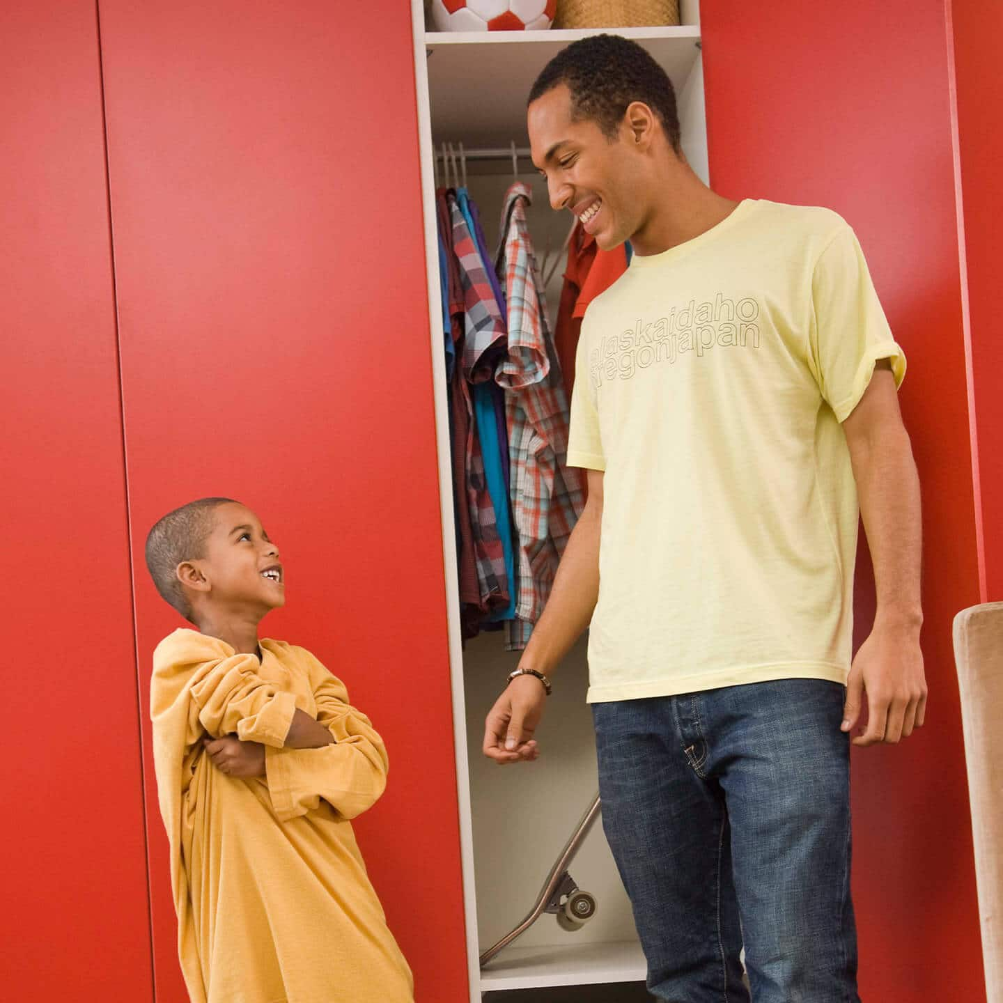 Father and son in front of a closet