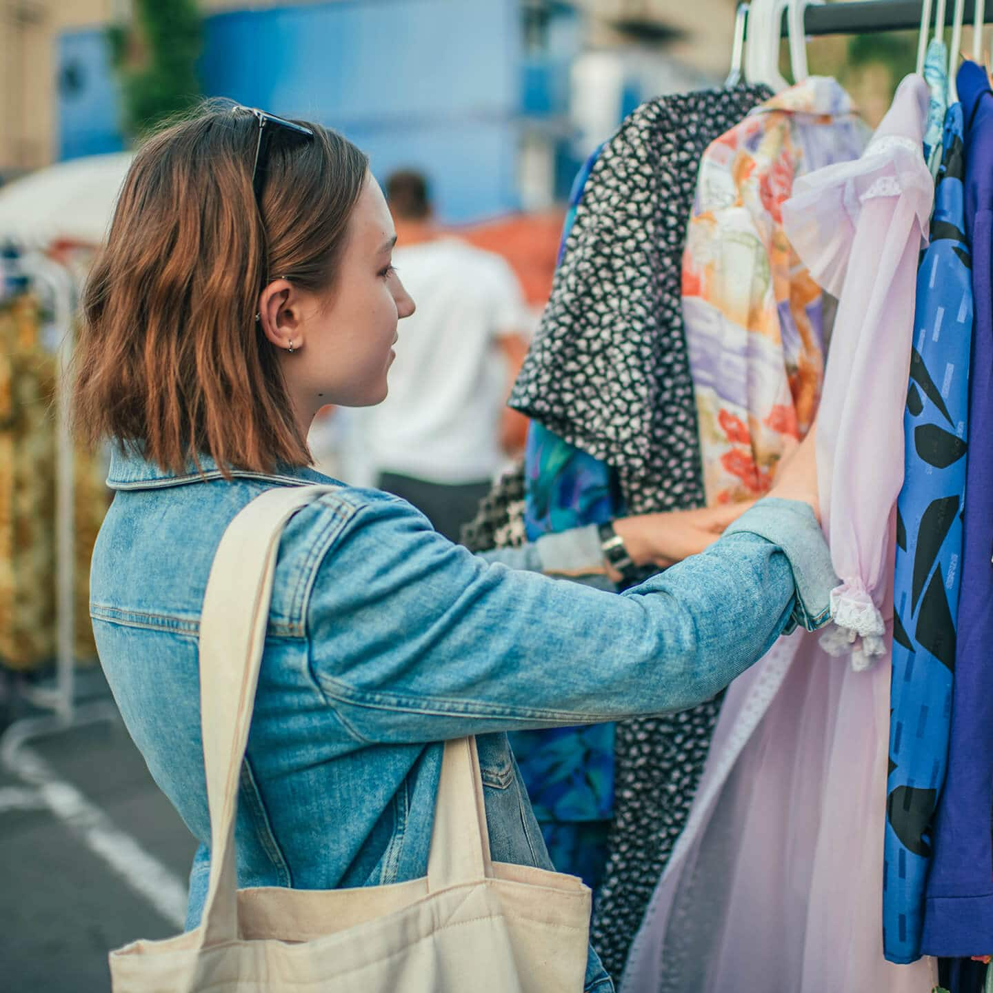 Woman searching for clothes on a flea market