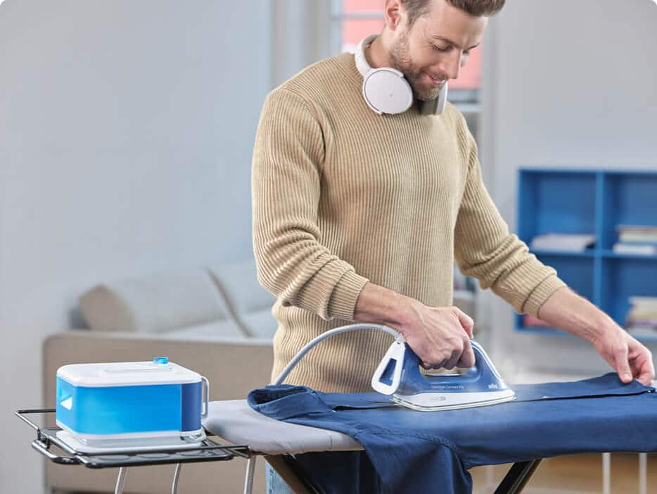 Man ironing with a Braun CareStyle steam iron